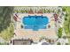 Aerial view of a stunning swimming pool with a built-in spa, surrounded by lush landscaping and patio at 1430 Rosehill Dr, Waxhaw, NC 28173