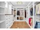 Spacious walk-in closet with custom shelving, ample storage, and hardwood floors at 1430 Rosehill Dr, Waxhaw, NC 28173