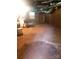 Unfinished basement with exposed ductwork, utility sink and toilet, and concrete floor at 1628 Cecelia Dr, Gastonia, NC 28054