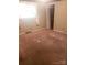 Neutral bedroom featuring tan carpet, a window with drapes, and a closet with bi-fold doors at 1628 Cecelia Dr, Gastonia, NC 28054