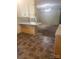 An eat-in kitchen with white cabinets, laminate countertops and an open view to another room at 1628 Cecelia Dr, Gastonia, NC 28054