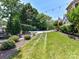 Expansive backyard with a well-manicured lawn, swimming pool, and fire pit area perfect for outdoor enjoyment at 18618 Rollingdale Ln, Davidson, NC 28036