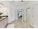 Spacious bathroom features double doors to the main bedroom, a granite vanity and tile flooring at 18618 Rollingdale Ln, Davidson, NC 28036