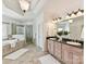 The bathroom has a tile floor, walk in shower, soaking tub, and double sink vanity at 18618 Rollingdale Ln, Davidson, NC 28036