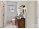 Bathroom with a vanity, antique mirror, decorative lights, and tiled floor at 18618 Rollingdale Ln, Davidson, NC 28036