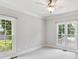 Bedroom with carpeted floor, neutral paint and two large windows overlooking the backyard at 18618 Rollingdale Ln, Davidson, NC 28036