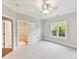 Bedroom features light paint color, ceiling fan, and access to a bathroom at 18618 Rollingdale Ln, Davidson, NC 28036