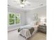 Bright bedroom boasts a single bed, a ceiling fan, and a sun-filled window view at 18618 Rollingdale Ln, Davidson, NC 28036