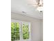 Bedroom with ceiling fan featuring windows with views of the lush outdoor landscape at 18618 Rollingdale Ln, Davidson, NC 28036