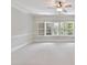 Expansive bonus room features neutral walls and carpet, with bright windows and natural light at 18618 Rollingdale Ln, Davidson, NC 28036