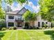 Beautiful brick home showcasing lush green lawn, inviting entryway, and charming balcony at 18618 Rollingdale Ln, Davidson, NC 28036