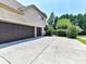 Spacious three-car garage with ample driveway space, located on a beautifully landscaped property, providing convenience and curb appeal at 18618 Rollingdale Ln, Davidson, NC 28036