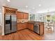 Kitchen featuring stainless appliances, wood cabinetry, granite counters, and a breakfast nook at 18618 Rollingdale Ln, Davidson, NC 28036