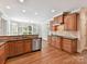 Kitchen featuring stainless appliances, wood cabinetry, granite counters, and hardwood floors at 18618 Rollingdale Ln, Davidson, NC 28036