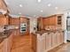 Kitchen with wood cabinets, granite counters, stainless appliances, and hardwood floors at 18618 Rollingdale Ln, Davidson, NC 28036