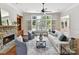 Bright living room featuring a stone fireplace, built-in shelves and a large window at 18618 Rollingdale Ln, Davidson, NC 28036
