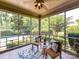Cozy screened porch with ample seating overlooking a swimming pool and lush landscaping at 18618 Rollingdale Ln, Davidson, NC 28036