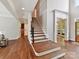 Elegant foyer features a staircase with hardwood steps and floors and views into other rooms at 18618 Rollingdale Ln, Davidson, NC 28036