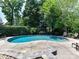 Sparkling swimming pool surrounded by a patio and lush greenery, perfect for summer enjoyment and relaxation at 18618 Rollingdale Ln, Davidson, NC 28036