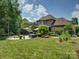 Beautiful backyard with patio, outdoor dining area, and lush landscaping at 213 Cowboys Cir, Rock Hill, SC 29732