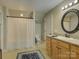 Bathroom featuring a vanity with a round mirror, toilet, and a shower with curtain at 213 Cowboys Cir, Rock Hill, SC 29732