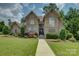 Charming stone and brick home with well-manicured lawn and beautiful landscaping at 213 Cowboys Cir, Rock Hill, SC 29732
