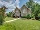 Charming stone and brick home with well-manicured lawn and beautiful landscaping at 213 Cowboys Cir, Rock Hill, SC 29732