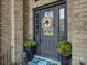 Elegant front door with decorative wreath and potted flowers at 213 Cowboys Cir, Rock Hill, SC 29732