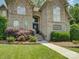 A welcoming front entrance with brick and stone facade, and lush landscaping at 213 Cowboys Cir, Rock Hill, SC 29732