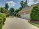 A three car garage with a wide driveway and neatly trimmed landscaping at 213 Cowboys Cir, Rock Hill, SC 29732