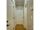 Hallway with multiple doors, hardwood floors, and neutral wall color offers access to various rooms at 213 Cowboys Cir, Rock Hill, SC 29732