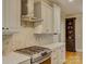 Gourmet kitchen with stainless steel appliances, white cabinets, and stylish tile backsplash at 213 Cowboys Cir, Rock Hill, SC 29732