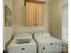 Bright laundry room includes washer, dryer, upper cabinets, and a window for natural light at 213 Cowboys Cir, Rock Hill, SC 29732