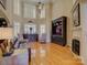 Open living room featuring large windows, hardwood floors, a fireplace, and plenty of natural light at 213 Cowboys Cir, Rock Hill, SC 29732