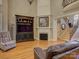 Well-lit living room with hardwood floors, a fireplace, and staircase at 213 Cowboys Cir, Rock Hill, SC 29732