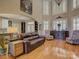 Bright living room with hardwood floors, large windows with shutters, and elegant furniture at 213 Cowboys Cir, Rock Hill, SC 29732