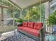 Cozy screened-in porch with red outdoor seating and views of surrounding trees at 213 Cowboys Cir, Rock Hill, SC 29732
