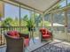 Cozy screened-in porch with red outdoor seating and views of the trees at 213 Cowboys Cir, Rock Hill, SC 29732