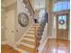Elegant staircase with wood treads, iron railings, and a large front door with glass panels at 213 Cowboys Cir, Rock Hill, SC 29732