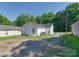 Rear of white house with detached garage and an unpaved driveway at 2414 Lane St, Kannapolis, NC 28083