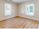 Bedroom with wood-look floors, freshly painted walls and windows for natural light at 2414 Lane St, Kannapolis, NC 28083