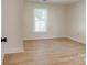 Bedroom with wood-look flooring, freshly painted walls and natural light at 2414 Lane St, Kannapolis, NC 28083