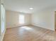 Bedroom featuring wood-look flooring and lots of light from a large window at 2414 Lane St, Kannapolis, NC 28083