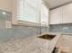 Close-up shot of new kitchen with modern faucet, granite counters, and tiled backsplash at 2414 Lane St, Kannapolis, NC 28083