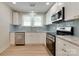 Well-lit kitchen featuring white cabinets, stainless appliances, and a modern sink area at 2414 Lane St, Kannapolis, NC 28083