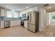 Modern kitchen featuring stainless steel appliances and ample cabinet space with a refrigerator at 2414 Lane St, Kannapolis, NC 28083