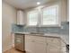 Bright, renovated kitchen featuring granite countertops and new stainless steel dishwasher and sink at 2414 Lane St, Kannapolis, NC 28083