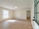 Living room featuring wood-look flooring and lots of light from a large window at 2414 Lane St, Kannapolis, NC 28083