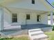 Close-up of a house's inviting covered porch, complete with stairs and white pillars at 2414 Lane St, Kannapolis, NC 28083