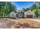 Charming single-story home with a modern design, blue door, gray siding, and a well-manicured lawn at 252 Teeter Rd, Mooresville, NC 28115